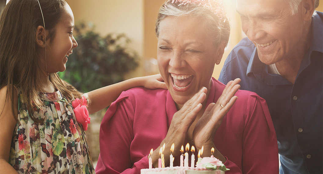 A child and an senior couple celebrating a 65th birthday